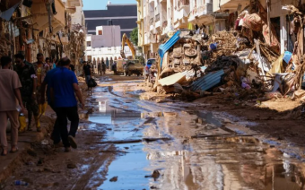 Members of the rescue teams from the Egyptian army carry a dead body as they walk in the mud between the destroyed buildings, after a powerful storm and heavy rainfall hit Libya, in Derna, Libya, September 13. REUTERS/Ahmed Elumami