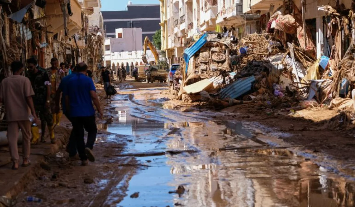 Members of the rescue teams from the Egyptian army carry a dead body as they walk in the mud between the destroyed buildings, after a powerful storm and heavy rainfall hit Libya, in Derna, Libya, September 13. REUTERS/Ahmed Elumami