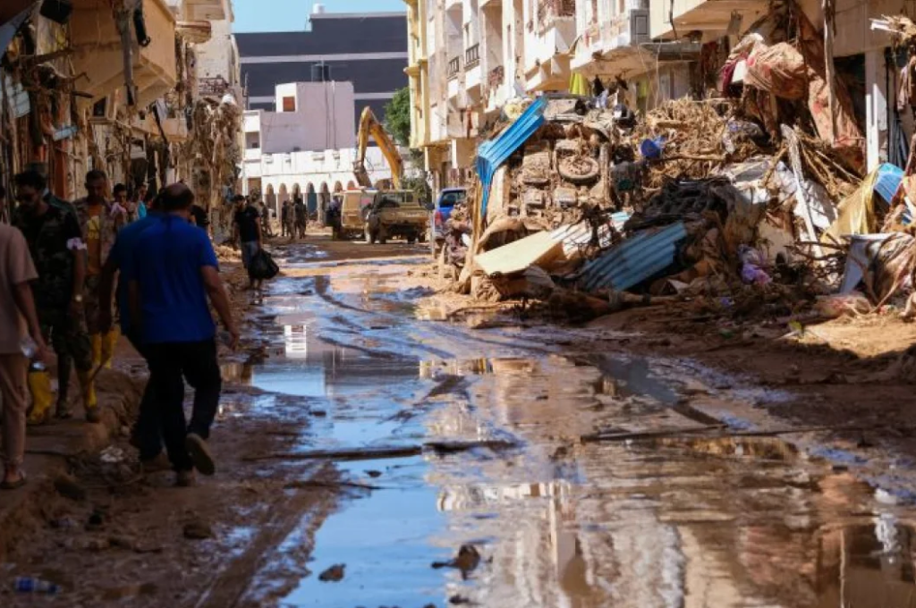 Members of the rescue teams from the Egyptian army carry a dead body as they walk in the mud between the destroyed buildings, after a powerful storm and heavy rainfall hit Libya, in Derna, Libya, September 13. REUTERS/Ahmed Elumami